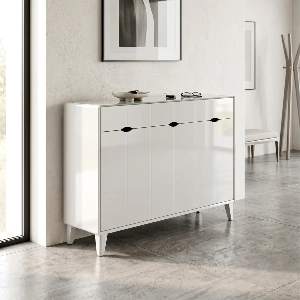 White dresser with black handles in a room with light-colored walls and flooring