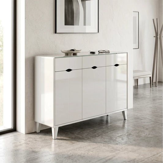 White dresser with black handles in a room with light-colored walls and flooring