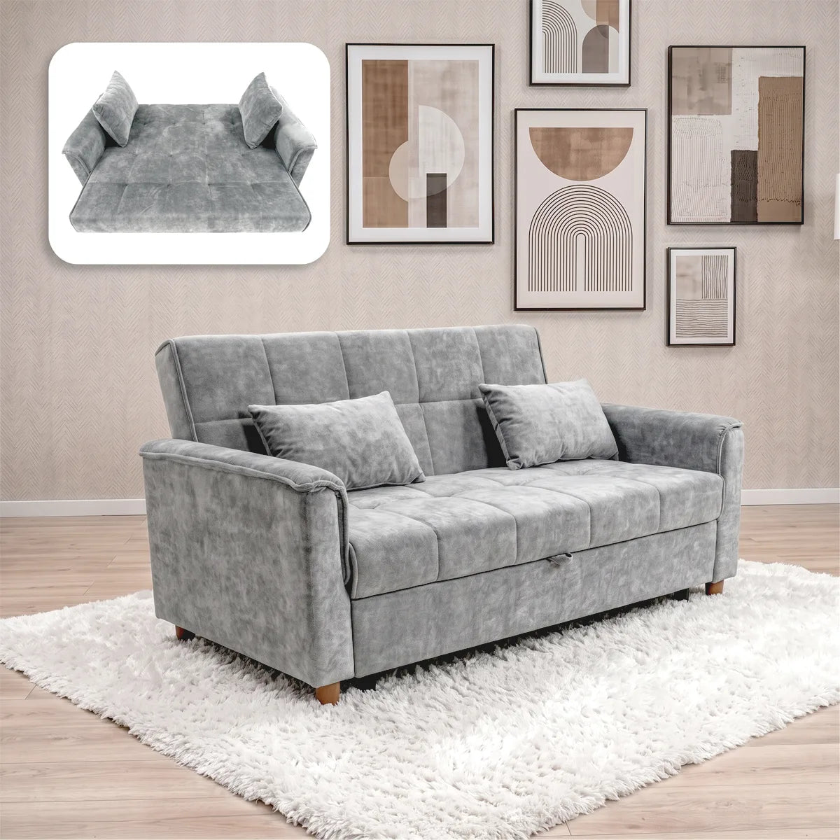 A gray upholstered loveseat sofa with two matching throw pillows, shown in a styled living room setting on a white shag rug. The image also includes a floating inset at the top left showing the sofa folded into a bed.