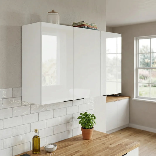 White high-gloss wall cabinets installed in a modern kitchen with a white subway tile backsplash, light wood countertops, and a window.
