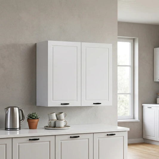 White wall-mounted kitchen cabinets with black handles, installed above a white countertop in a modern kitchen with a window and neutral walls